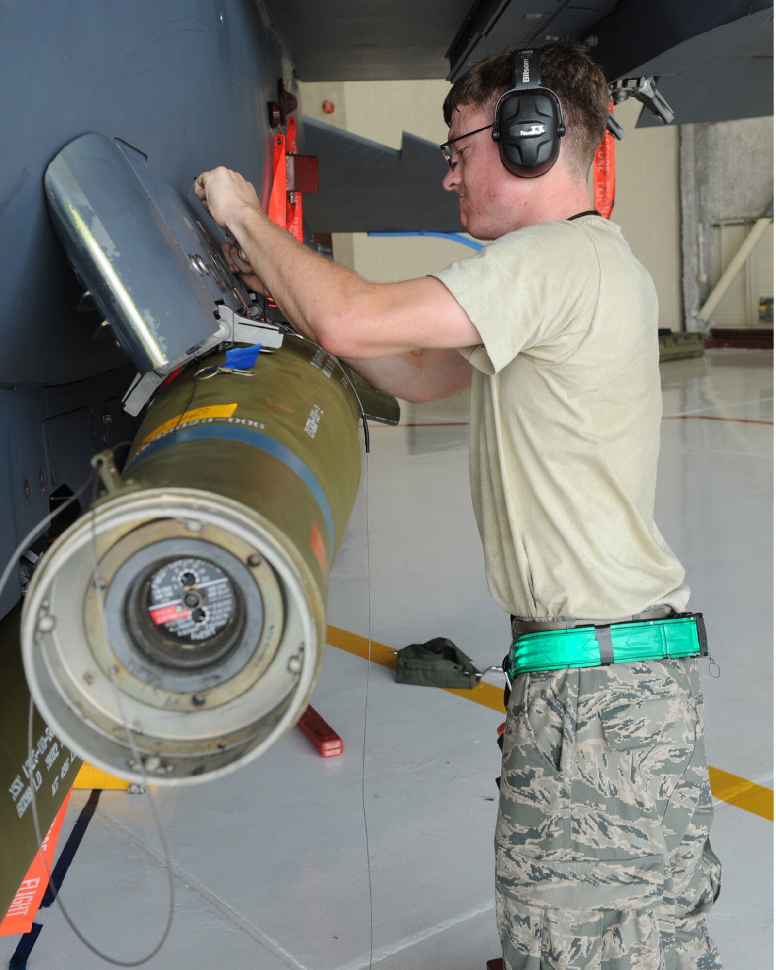 Airman 1st Class Steven Peters, 335th Aircraft Maintenance Unit weapons load crew member, removes cart retainers on an F-15E Strike Eagle during a load crew competition on Seymour Johnson AFB, N.C., July 17, 2009. Cart retainer removal allows Airman Peters to install impulse carts that enable the bomb to eject from the aircraft. (U.S. Air Force photo by Airman 1st Class Whitney S. Lambert)
