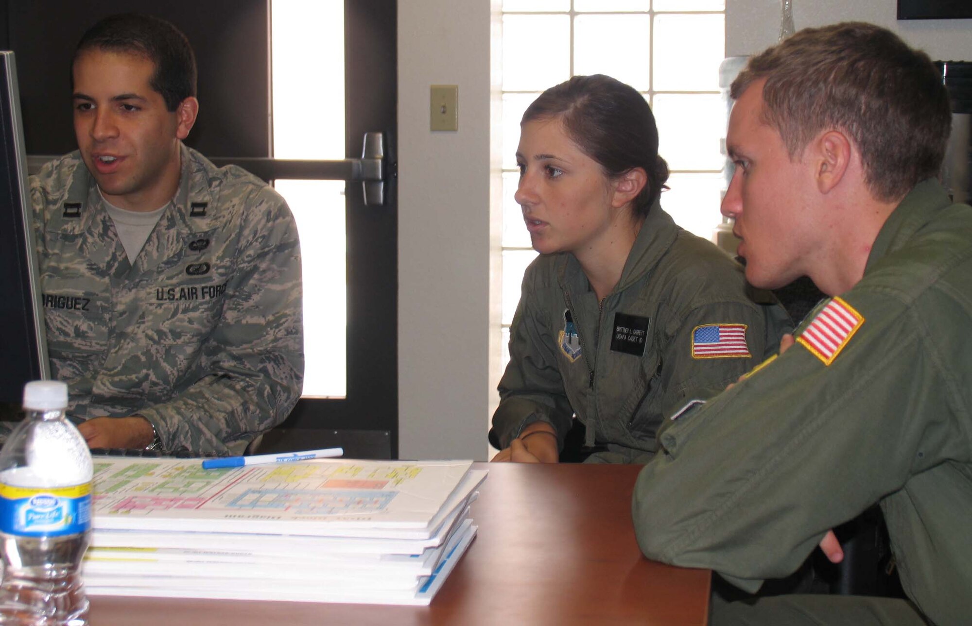 (Left to right) Capt. James Rodriguez from the Air Force Operational Test and Evaluation Center’s Detachment 3 at Kirtland Air Force Base, N.M., works with Cadets First Class Brittney Garrett and Mark Price as they analyze questionnaire and reliability data for the Department of Defense National Airspace System during the U.S. Air Force Academy’s Cadet Summer Research Program. During the five-week program, cadets gained hands-on exposure to operational testing processes, products, and experiences. (U.S. Air Force photo).