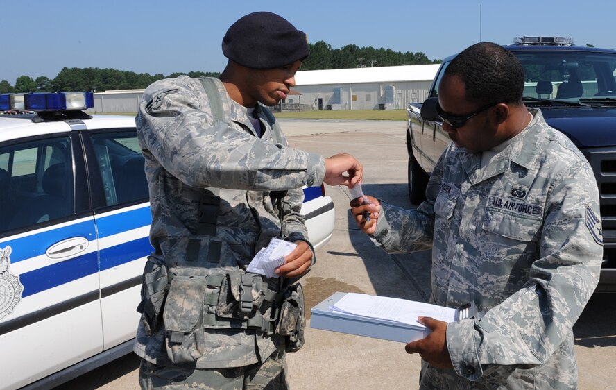 Staff Sgt. Deshunn Foster, 4th Operations Support Squadron deputy airfield manager, checks a flight line driver's license on Seymour Johnson Air Force Base, N.C., July 14, 2009. Sergeant Foster is responsible for overseeing the flight line driving program for approximately 25 units of the 4th Fighter Wing. (U.S. Air Force photo by Airman 1st Class Gino Reyes)