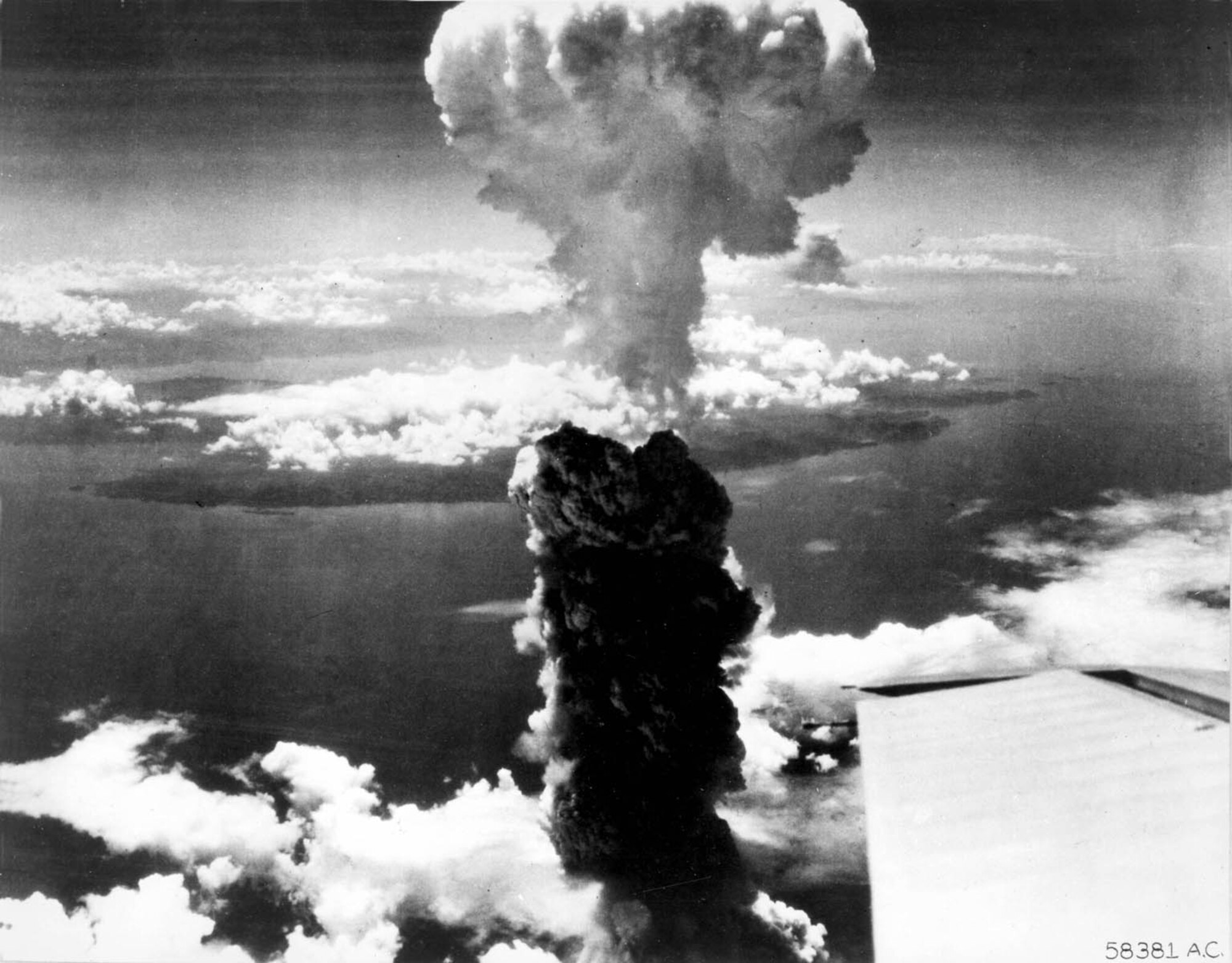 Smoke billows up over Nagasaki, Japan after bombing by atomic bomb on 9 August 1945.  Two planes of the 509th Composite Group, part of the 313th Wing of the 20th Air Force, participated in this mission; one to carry the bomb, the other to act as escort. (Courtesy photo)