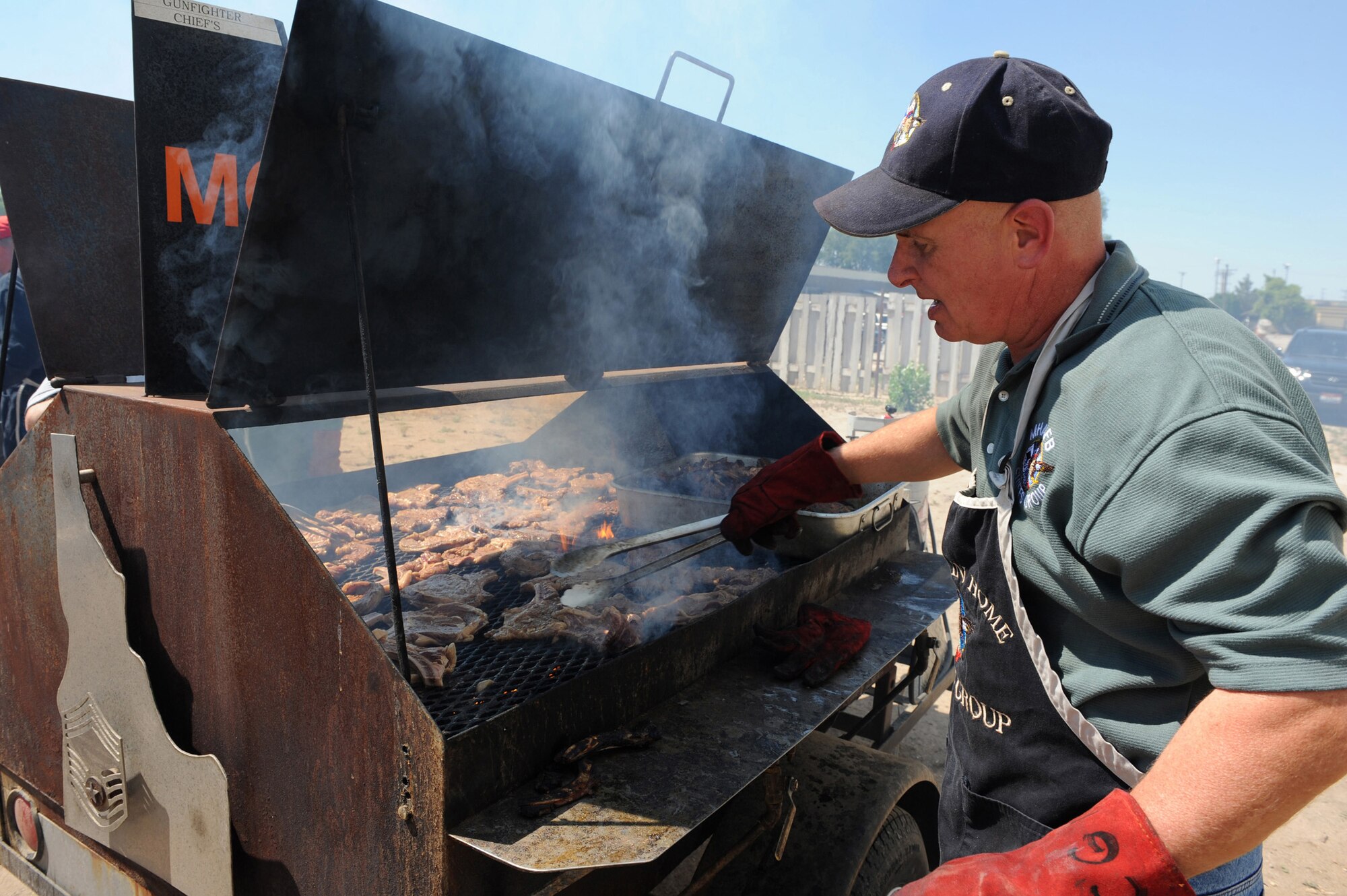 MOUNTAIN HOME AIR FORCE BASE, Idaho -- Chief Master Sgt. Kevin Curl, 366th Mission Support Group group enlisted manager, grills steaks at the community center during a Chief’s Steak Burn July 16. Money raised from steak burns help offset costs of quarterly and annual awards. The next steak burn is scheduled Aug. 19 at the community center from 11 a.m. to 1 p.m. (U.S. Air Force photo by Airman 1st Class Debbie Lockhart)