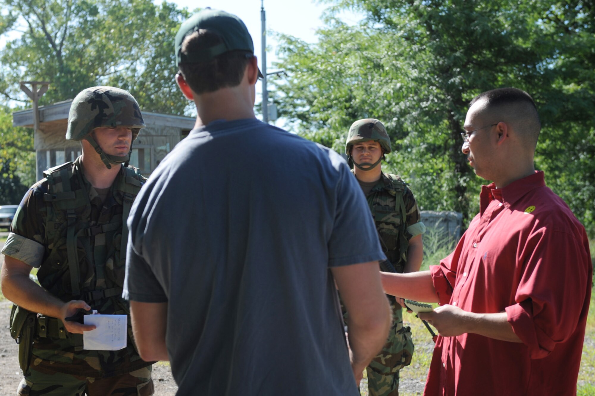 WHITEMAN AIR FORCE BASE, Mo. - Master of Arms 2nd Class David Edward checks IDs at the entry control point of Camp Arrowhead during the Navy Convoy Training Exercise July 17 - 19. (U.S. Air Force photo/ Senior Airman Jason Huddleston)