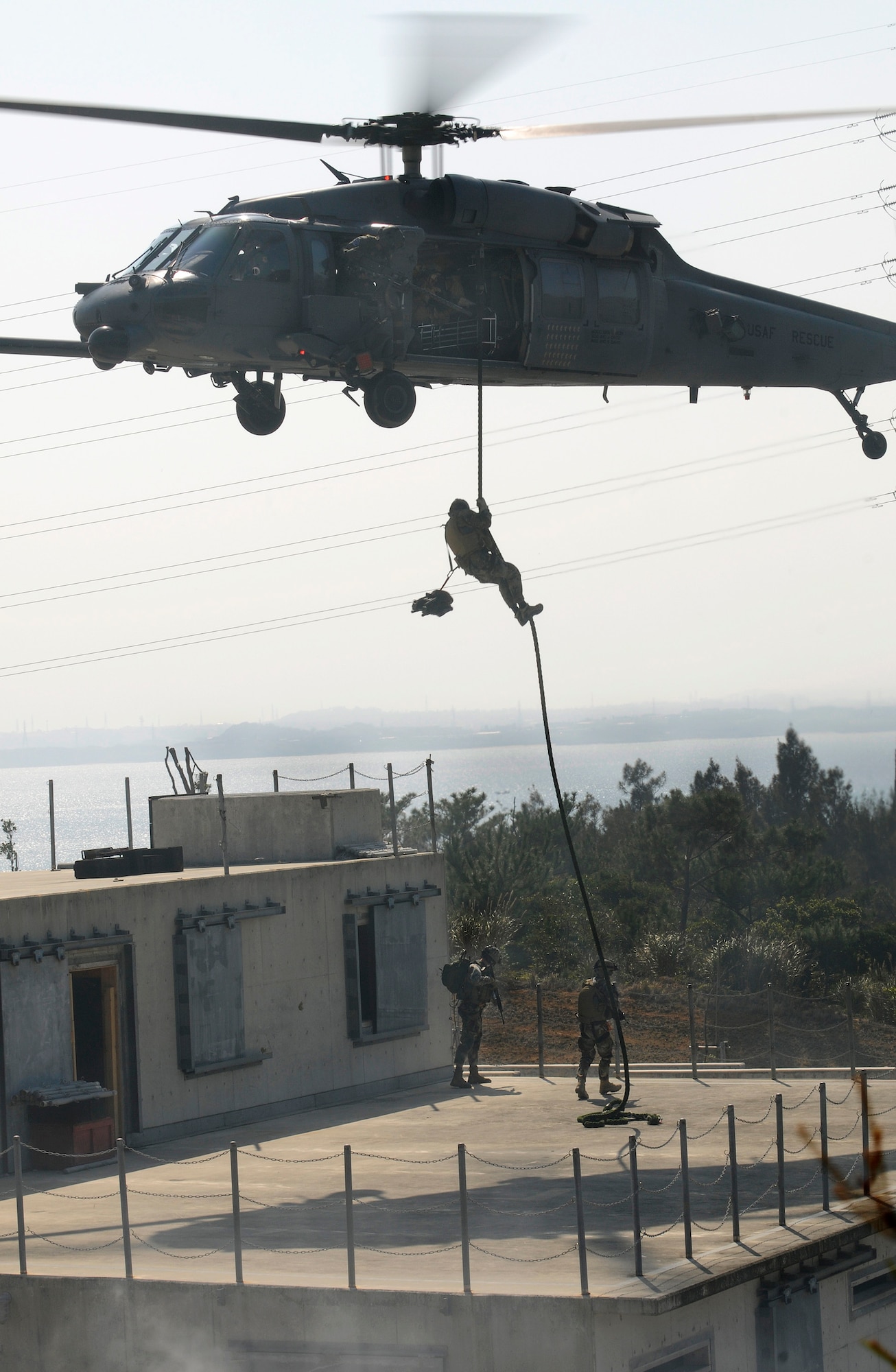 Pararescuemen assigned to the 31st Rescue Squadron at Kadena Air Base, Japan, fast rope from an HH-60G Pave Hawk helicopter during exercise Cope Angel 09-1 in Japan. (U.S. Air Force photo/Airman 1st Class Chad Warren) 