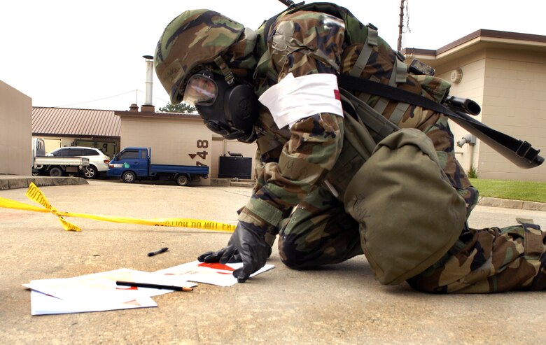 Senior Airman Richard Rodriguez writes the time and date on an unexploded ordinance recognition and reporting chart after setting up a cordon around a simulated UXO during exercise Beverly Bulldog 09-03 at Osan Air Base, Republic of Korea. Airman Rodriguez is a entry controller at the 51st Medical Group (U.S. Air Force photo/Senior Airman Stephenie Wade)