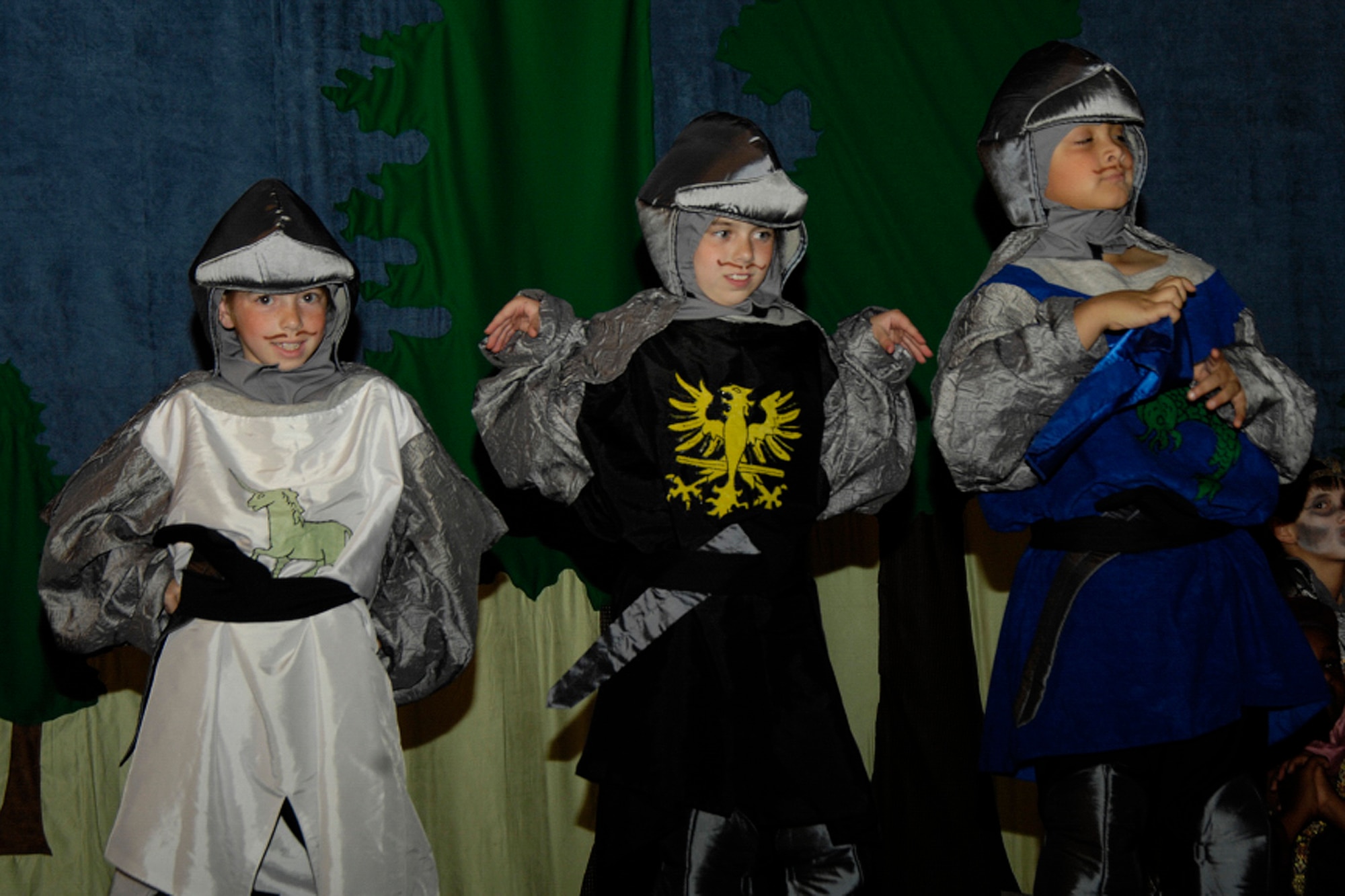 HANSCOM AIR FORCE BASE, Mass. - Hanscom children (left to right) Taylor Yanov,  Riley Gatlin and Jacob Curry perform as Knights of the Round Table in a Missoula Children’s Theater production of King Arthur’s Quest on July 18 at the Base Theater. (U.S. Air Force photo by Linda LaBonte Britt)
