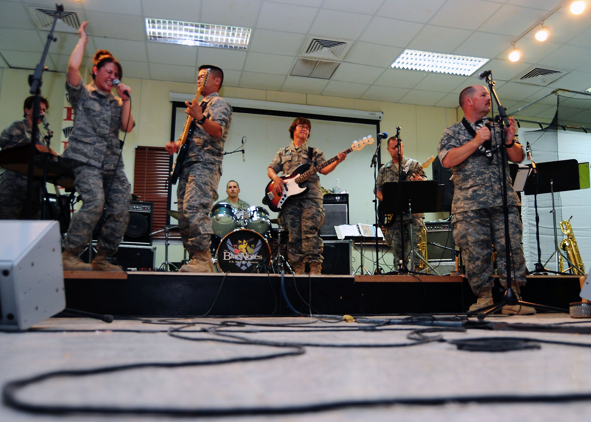 SOUTHWEST ASIA -- The Air Force Central Command band Sanora rocks out for members of the 386th Air Expeditionary Wing July 21. The concert is part of a month-long trip throughout the region. The band will travel to Camp Bucca, Iraq, before heading back to the states. (U.S. Air Force photo/Tony Tolley)