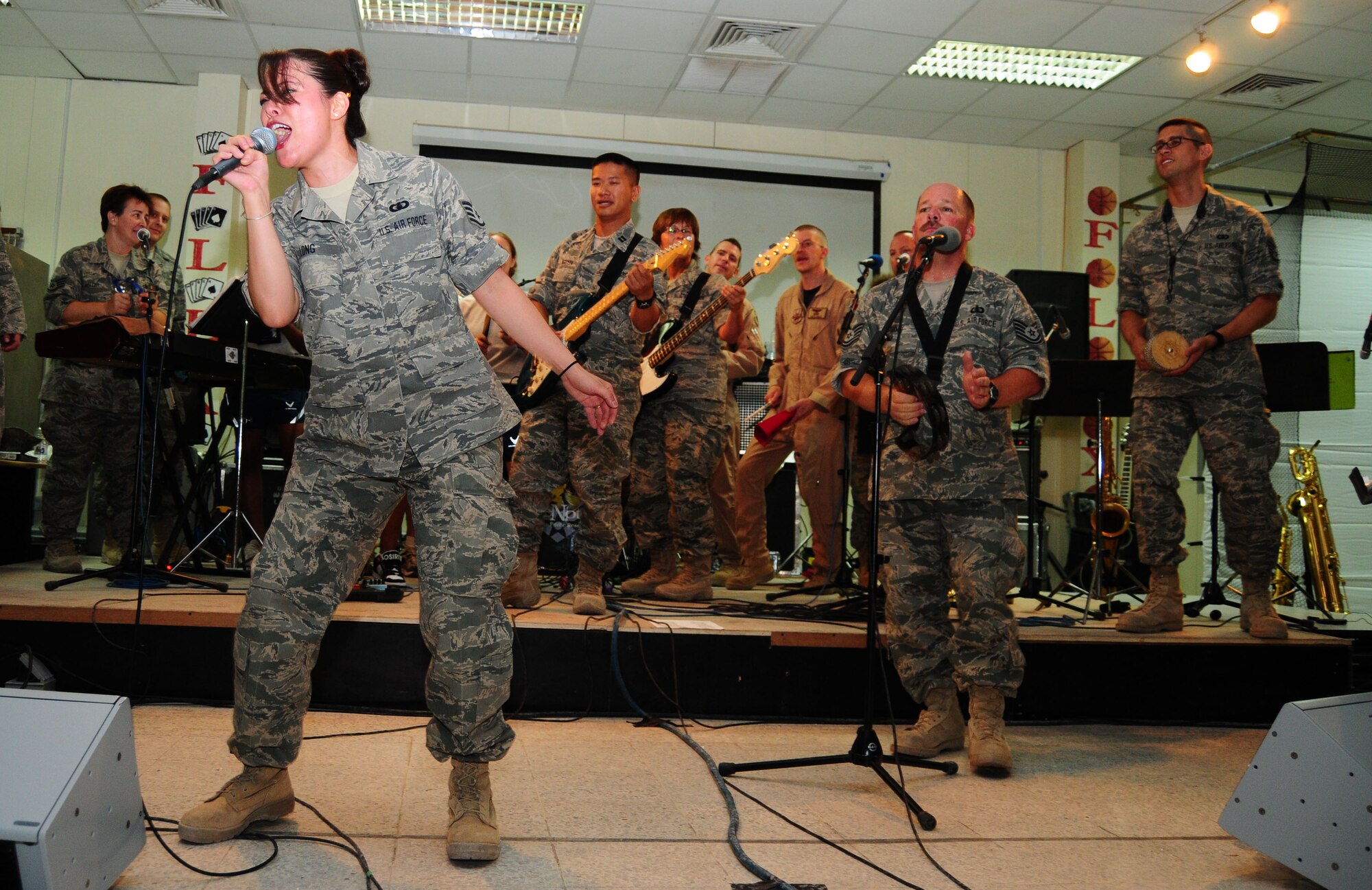 SOUTHWEST ASIA -- Staff Sgt. Angie Long, vocalist, deployed from 139th Airlift Wing, St. Joseph, Mo., leads the Air Force Central Command band Senora during a performance for the 386th Air Expeditionary Wing July 21. (U.S. Air Force photo/Tony Tolley)