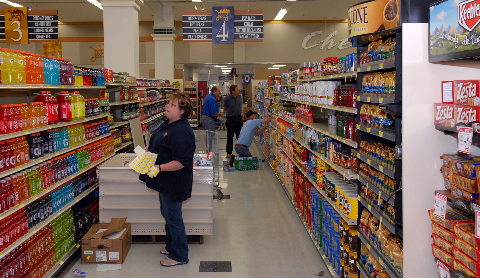 MISAWA AIR BASE, Japan -- Defense Commissary Agency employees and several volunteers help restock the newly installed shelves in the Commissary July 21. DECA employees were flown in specifically for the renovation. (U.S. Air Force photo/Staff Sgt. Phillip Butterfield)