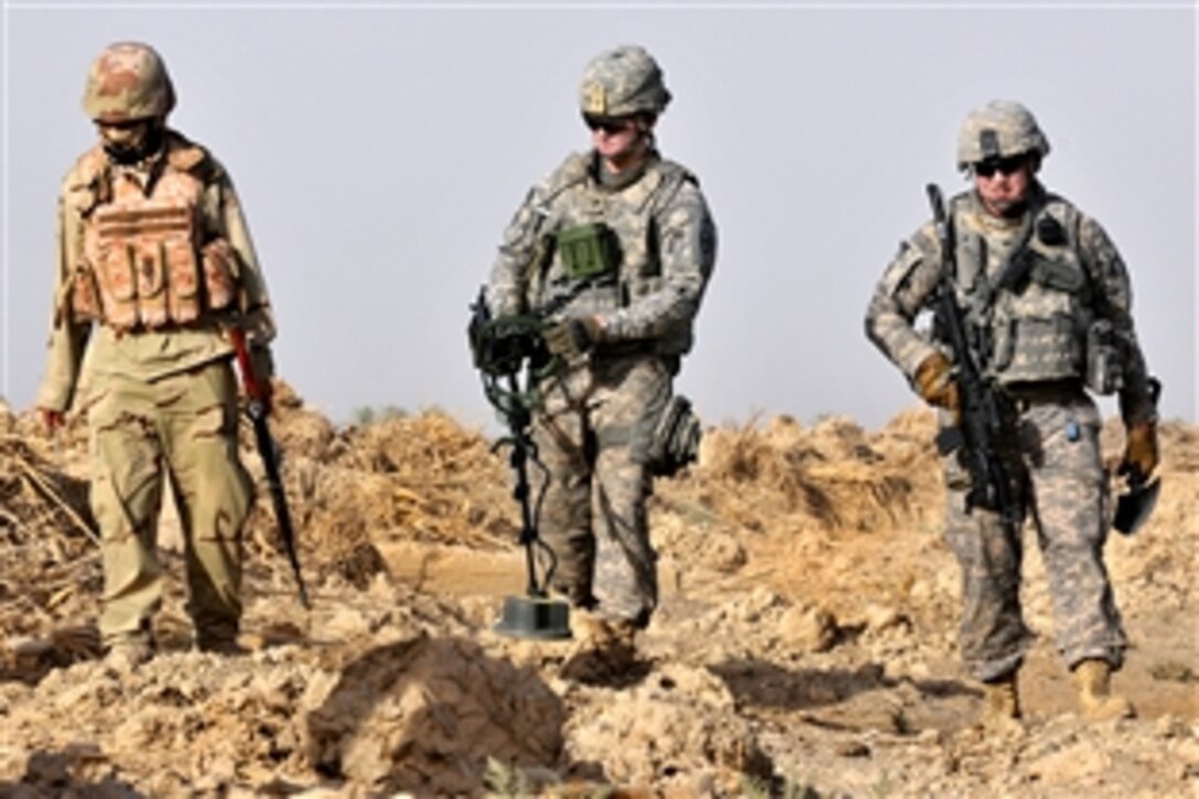 U.S. and Iraqi soldiers search for weapons caches in open fields in the Radwaniyah area outside Baghdad, July 18, 2009. The U.S. soldiers are assigned to the 1st Cavalry Division’s Comanche Troop, 1st Squadron, 150th Cavalry Regiment, 30th Heavy Brigade Combat Team.