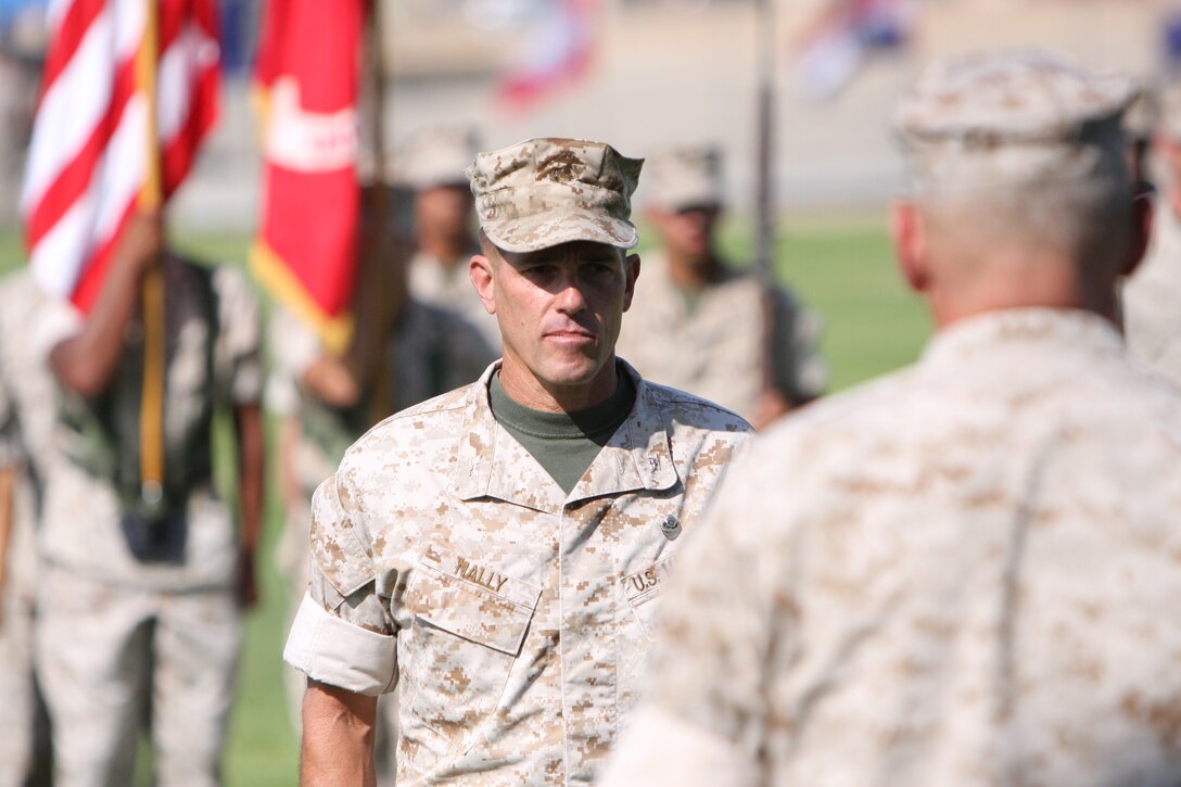 Col. Kevin Nally, the offgoing commander for the Marine Corps Communication-Electronics School, stands at attention before receiving a Legion of Merit from Maj. Gen. John Kelly, the commanding general of I Marine Expeditionary Force, during a MCCES change of command ceremony at the Combat Center’s Lance Cpl. Torrey L. Gray Field July 23.