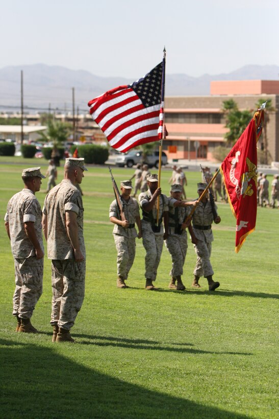 Col. David Terando, the oncoming commander for the Marine Corps Communication-Electronics School, and Col. Kevin Nally, the outbound commander for MCCES, prepare to salute the colors during the pass and review at the MCCES change of command ceremony on Combat Center’s Lance Cpl. Torrey L. Gray Field July 23.