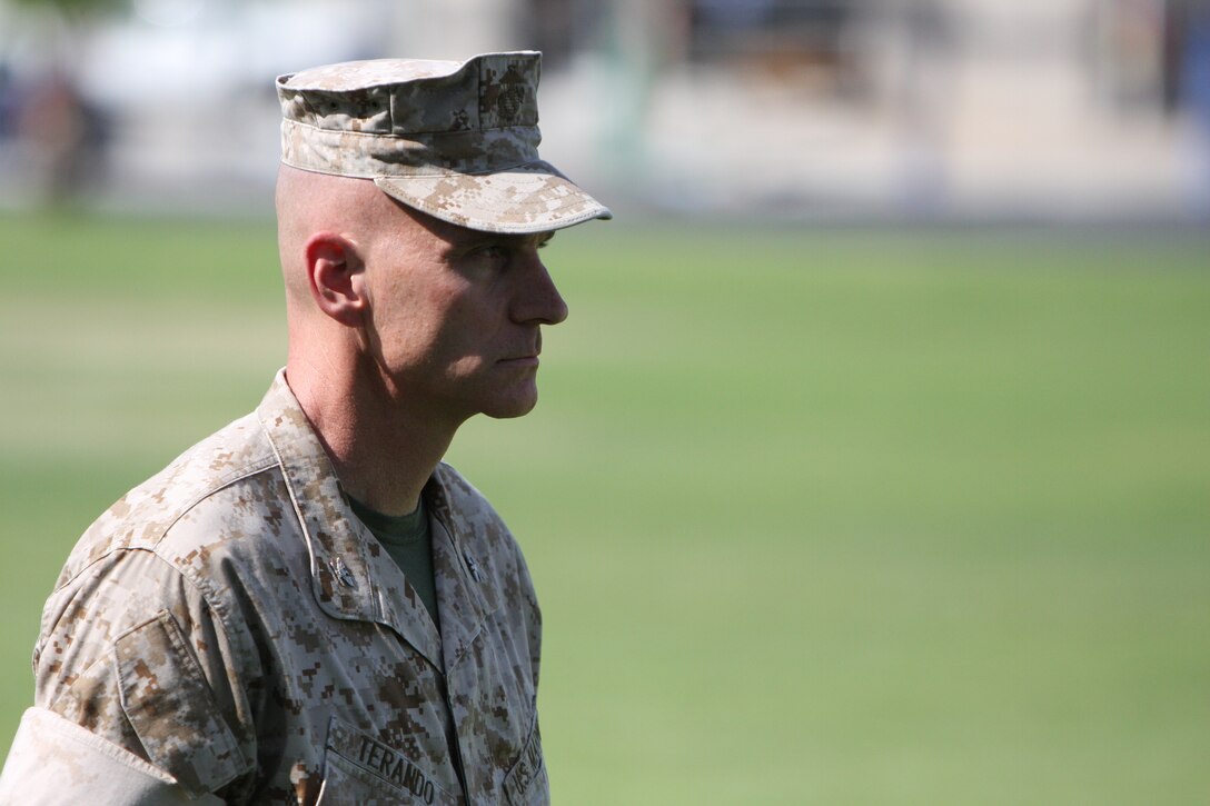 Col. David Terando, the oncoming commander for the Marine Corps Communication-Electronics School, stands at attention awaiting further instruction during the MCCES change of command ceremony at Combat Center’s Lance Cpl. Torrey L. Gray Field July 23.