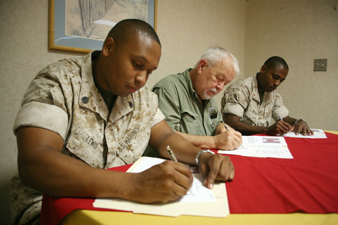 From left to right, Staff Sgt. Charles Lewis, Donald Sargent, and Chief Warrant Officer 2 Andra’ Busby mark their final decisions for the competition. Lewis is the Headquarters and Headquarters Squadron S-3 chief, Sargent is an industrial engineer at the air station’s facilities development and Busby is a personnel officer at the Installation Personnel Administration Center.