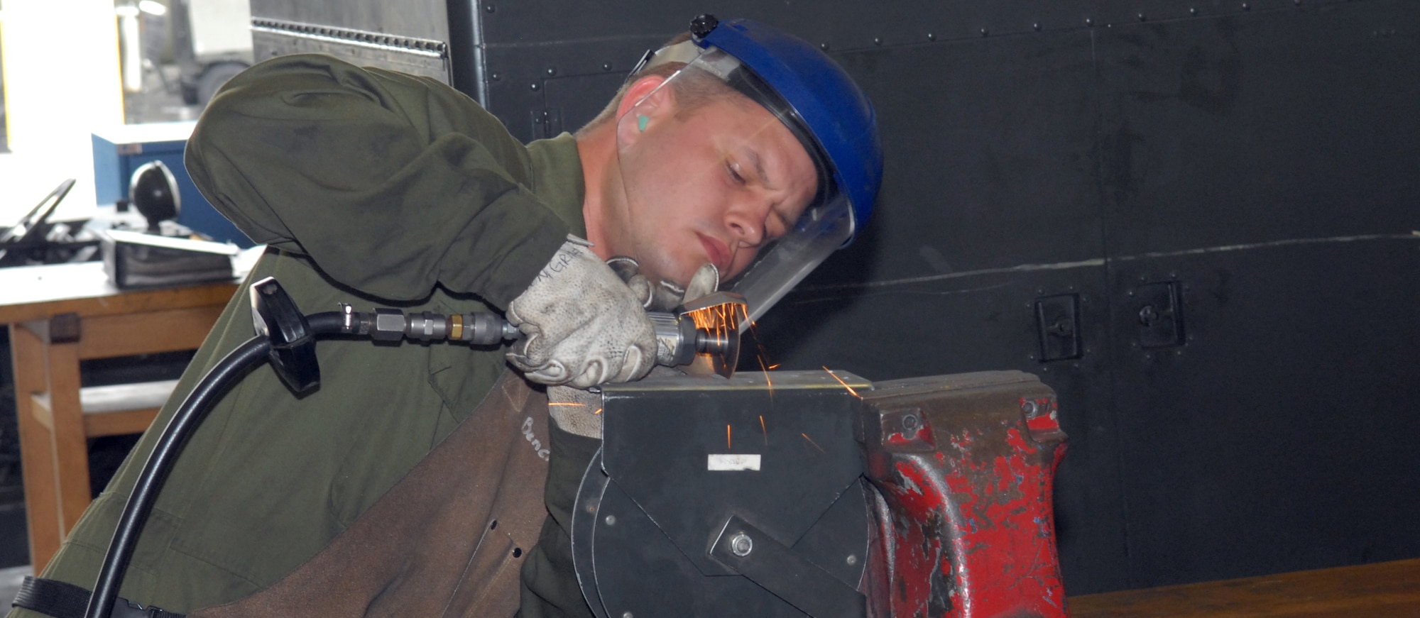 AGE of maintenance
MISAWA AIR BASE, Japan ? Staff Sgt. Christopher Starr, 35th Maintenance Squadron Aerospace Ground Equipment craftsman, cuts a piece of metal for a control lever bracket to a hydraulic test stand July 23 in the AGE maintenance building. Age technicians at times need to fabricate tools and equipment in order to maintain equipment used on the flightline. (Air Force photo/Staff Sgt. Phillip Butterfield)
