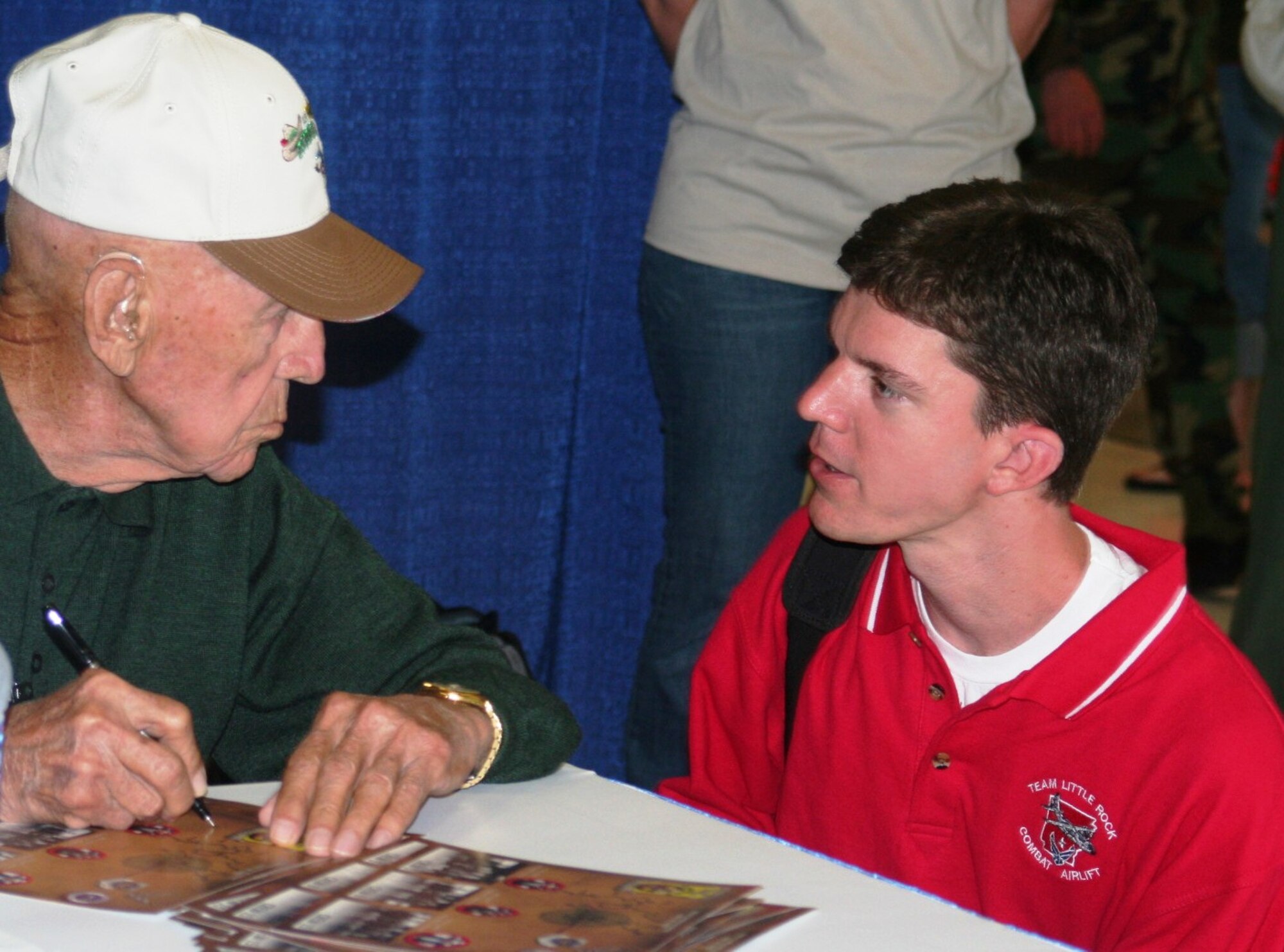 Retired Maj. Thomas C. Griffin, veteran of the Doolittle Raid of April 18, 1942, over Tokyo, Japan, signs an autograph for a participant in Air Mobility RODEO 2009 July 23 at McChord Air Force Base, Wash.  (U.S. Air Force Photo/Tech. Sgt. Scott T. Sturkol)