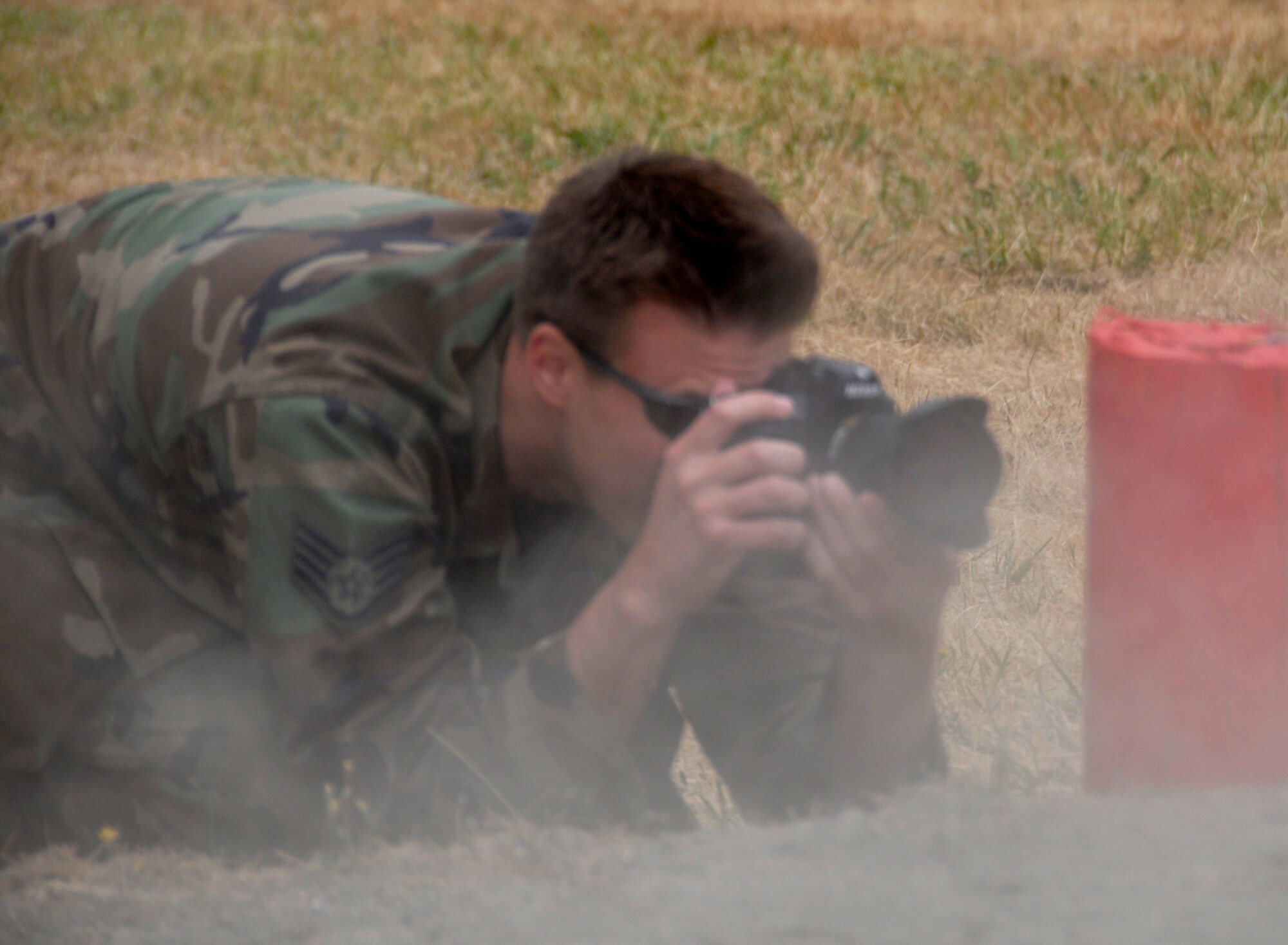 Staff Sgt. Stephen Schester, from the 4th Combat Camera Squadron, March Air Reserve Base, Calif., shoots photos during security forces competition for Air Mobility RODEO 2009 July 23 at McChord Air Force Base, Wash.  (U.S. Air Force Photo/Capt. Karen O'Neill)