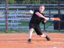 Ethan Kleckler takes a swing during an intramural softball game here July 21. The game was held between the 437th Aircraft Maintenance Squadron's Team 1 and the 437th Logistics Readiness Squadron. Kleckler is with the 437 LRS. (U.S. Air Force photo/Staff Sgt. Daniel Bowles) 