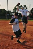 Michael Tate is safe at first base as Matthew Pease leaps to catch an overthrown ball during an intramural softball game here July 21. 437th Security Forces Squadron won against 437th Operations Support Squadron 10-0. Tate is with the 437 OSS and Pease is with the 437 SFS. (U.S. Air Force photo/Staff Sgt. Daniel Bowles)