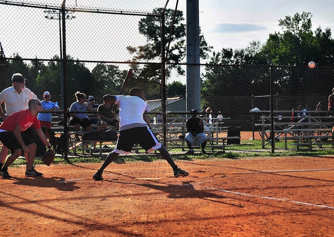 Jamaal Avington keeps his eye on the ball before taking a swing during a close intramural softball game here July 21. Avington is with the 437th Force Support Squadron. (U.S. Air Force photo/Staff Sgt. Daniel Bowles)