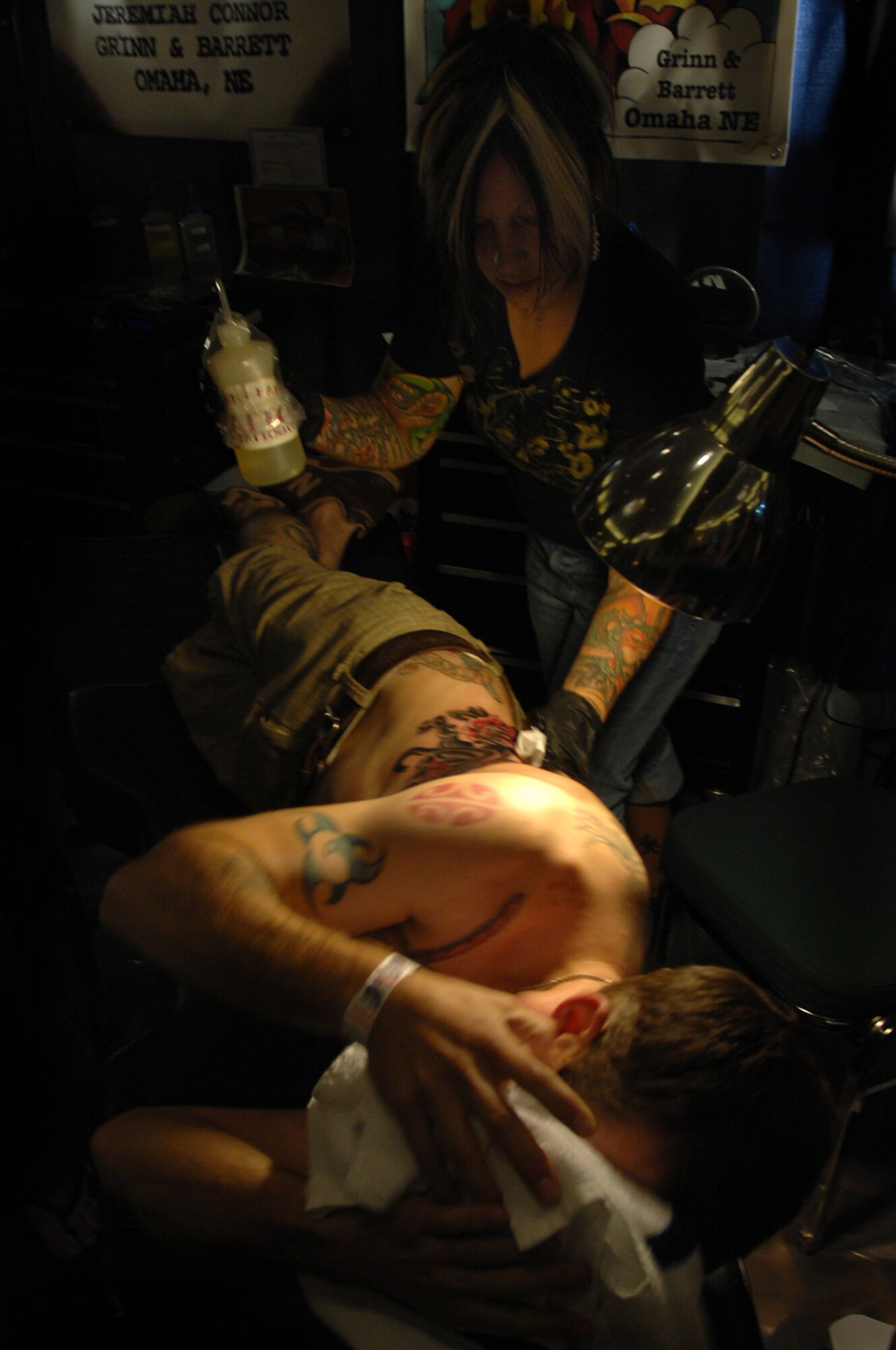 KANSAS CITY, Mo. - Jen Beirola, prior U.S. Air Force enlisted, prepares to irrigate a fresh tattoo after putting the finishing touches on it at an annual tattoo convention July 19. Jen discovered her talent while serving in the Air Force and was inspired by the late graphic artist career field. Military members stationed at Whiteman were able to attend the convention and watch tattoo arts such as Jen perform their craft. (U.S. Air Force photo/Senior Airman Kenny Holston)