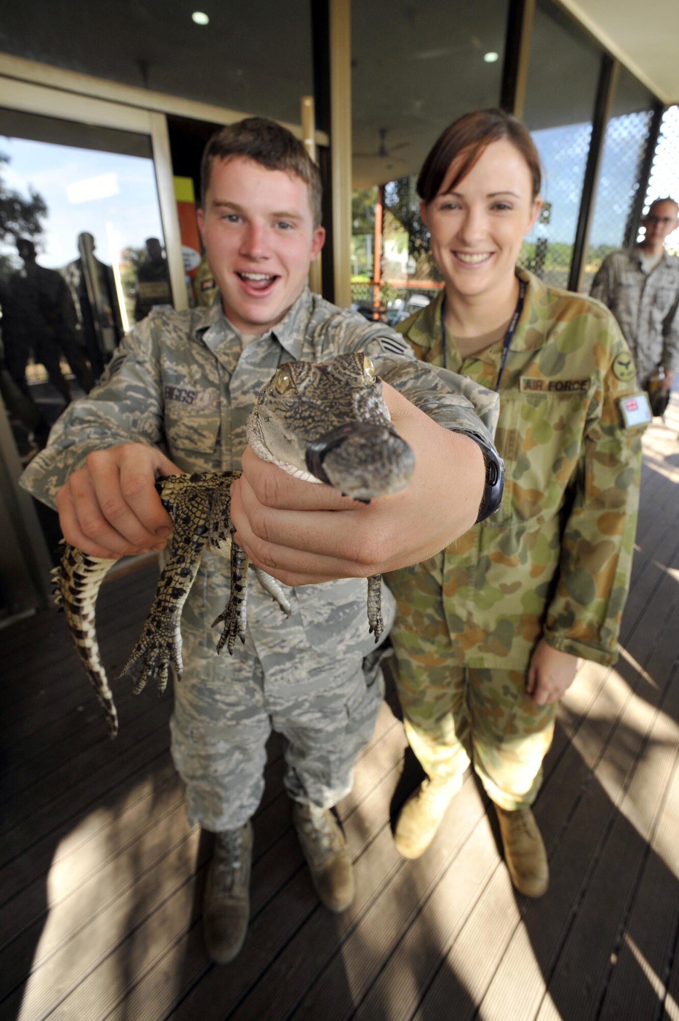 DARWIN, Australia – Senior Airman Joseph Biggs and Royal Australian Air Force Aircraftwoman Kellie Gill get up-close and personal with a baby crocodile at Crocodylus Park here July 21.  Airman Biggs is deployed to Australia from Kadena Air Base, Japan, and Aircraftwoman Gill is a clerk with the No. 322 Expeditionary Combat Support Squadron at RAAF Base Tindal.  Talisman Saber is a U.S.-Australian exercise aimed at improving interoperability between the two countries.  U.S. military members had opportunities to visit regional attractions during the exercise, which ends July 25.  (Royal Australian Air Force photo/ LAC Aaron Curran)