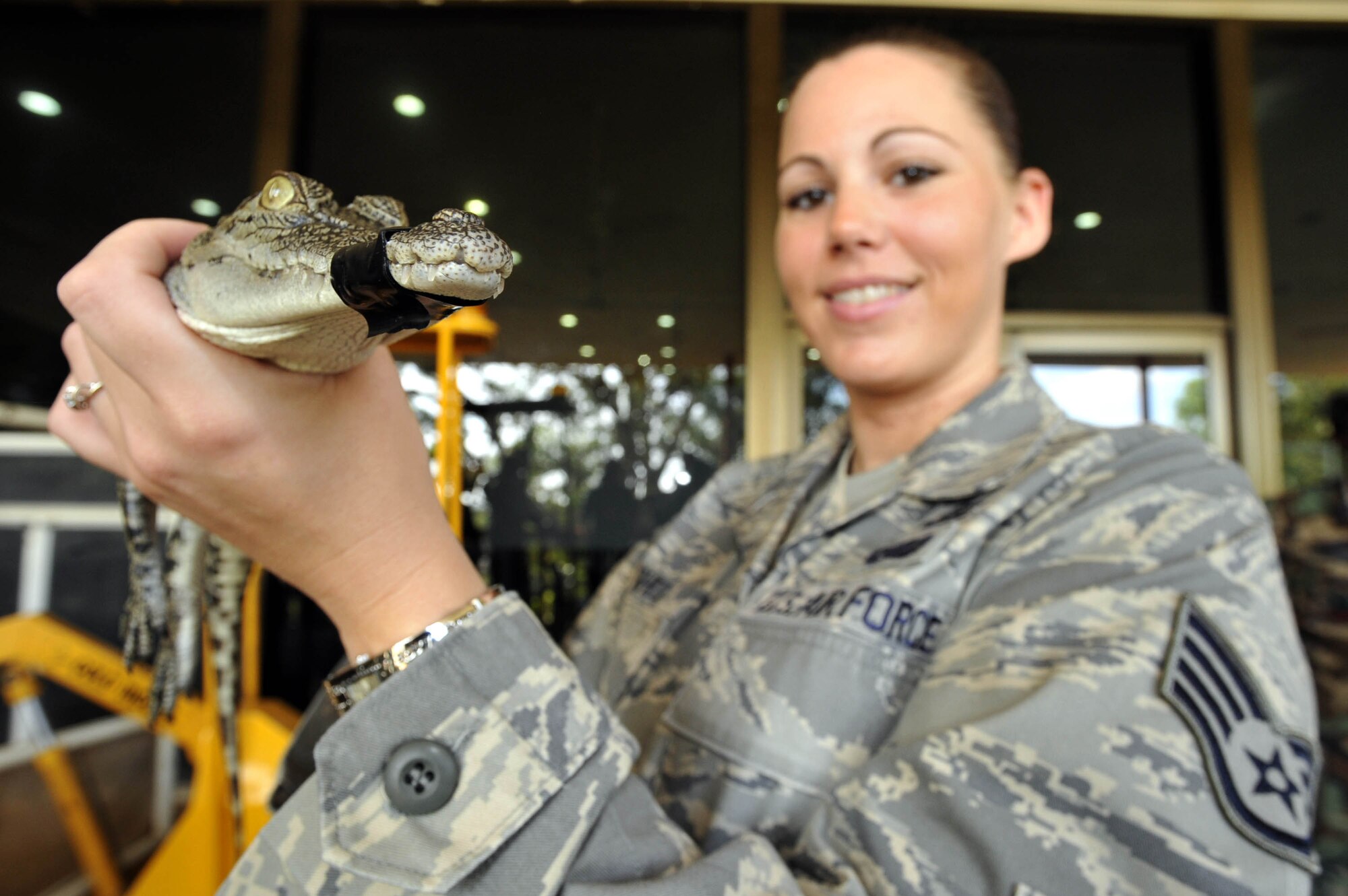 DARWIN, Australia – Staff Sgt. Kelly Hughes, deployed from Langley Air Force Base, Va., to Australia to support Talisman Saber 2009, gets up-close and personal with a baby crocodile at Crocodylus Park here July 21.  Talisman Saber is a U.S.-Australian exercise aimed at improving interoperability between the two countries.  U.S. military members had opportunities to visit regional attractions during the exercise, which ends July 25.  (Royal Australian Air Force photo/ LAC Aaron Curran)