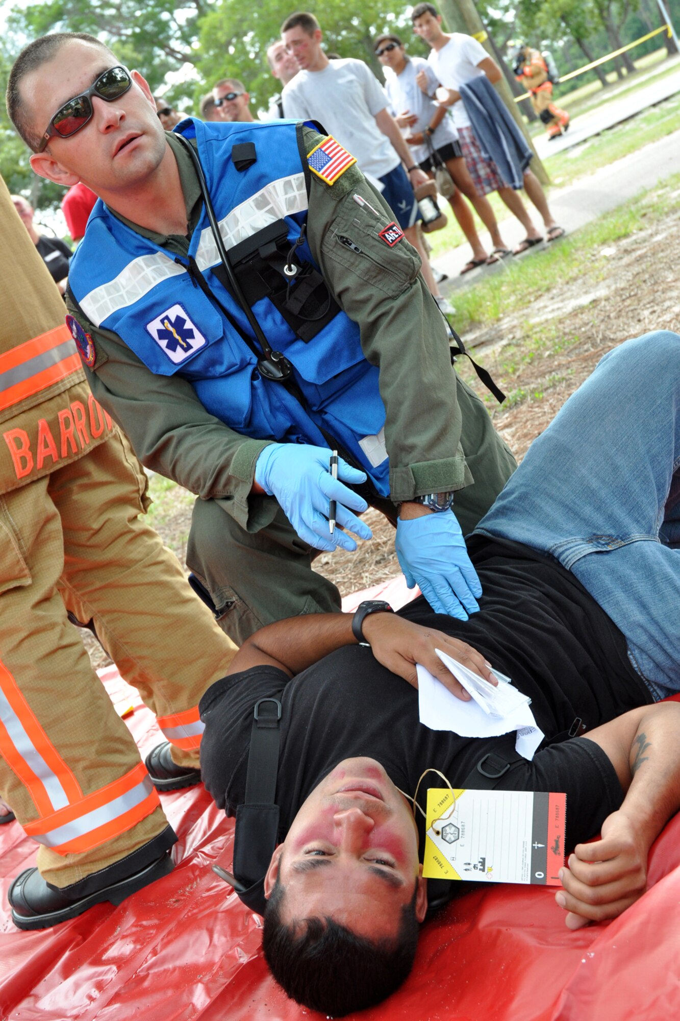 EGLIN AIR FORCE BASE, Fla. – Capt. Richard Speakman, 96th Aerospace Medicine Squadron, waits for assistance while tending to a blast injury victim during an exercise here, July 22. The exercise evaluated first responders and medics reaction to real-world crisis scenarios. The simulated explosion injured approximately 40 people and fatally wounded 13. The exercise also evaluated the base’s response to a threat situation with increase Force Protection levels. (U.S. Air Force photo/ Airman Anthony Jennings)