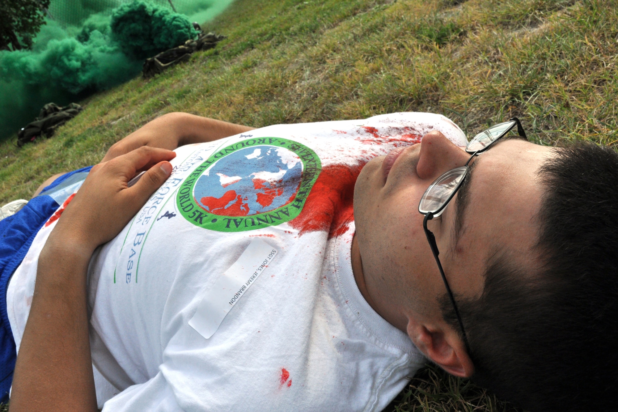 EGLIN AIR FORCE BASE, Fla. – Staff Sgt. Jeremy Jones, 96th Civil Engineer Squadron, lays motionless on the ground a few meters away from simulated explosion during an exercise here July 22. The exercise evaluated first responders and medics reaction to real-world crisis scenarios. The simulated explosion injured approximately 40 people and fatally wounded 13. The exercise also evaluated the base’s response to a threat situation with increase Force Protection levels. (U.S. Air Force photo/ Airman Anthony Jennings)