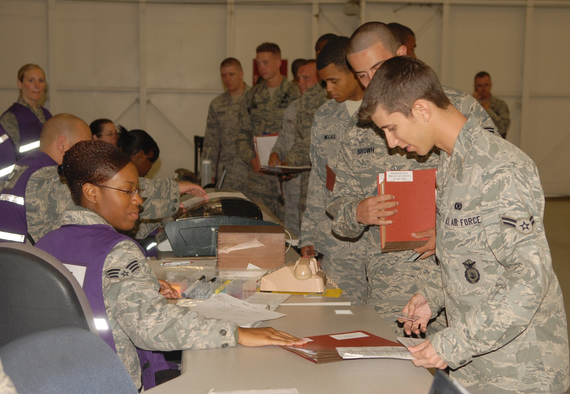 VANDENBERG AIR FORCE BASE, Calif. -- Senior Airman Kalaya Irby, a 30th Force Support Squadron customer service representative, assists Airmen to ensure the accuracy of their documents in preparation for future deployments at Vandenberg’s Installation Deployment Readiness Center here July 22. Airmen of the 30th Security Forces Squadron, process through the pre-deployment line before being cleared by the base to deploy to another location. (U.S. Air Force photo/Senior Airman Antoinette Lyons)