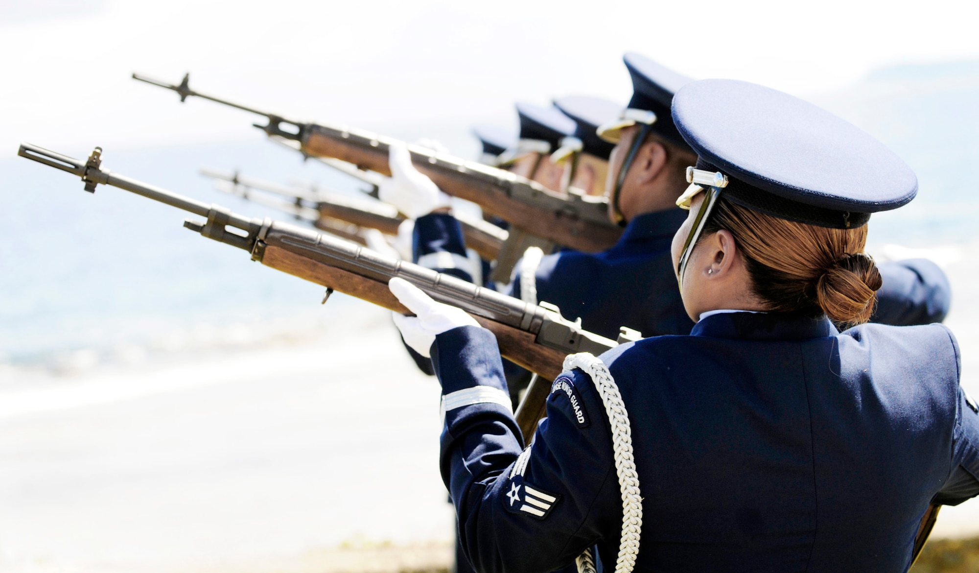 Airmen from the 36th Wing Honor Guard at Andersen Air Force Base, Guam, conduct a 21-gun salute July 20 during the RAIDR 21 Memorial ceremony at the Governor's Complex in Hagatna, Guam. Family and co-workers along with residents of the community honored the aircrew with the ceremony where a memorial dedicated to the Airmen was unveiled. The aircrew died when their B-52 Stratofortress crashed off the coast of Guam a year ago. (U.S. Air Force photo/Airman 1st Class Courtney Witt)