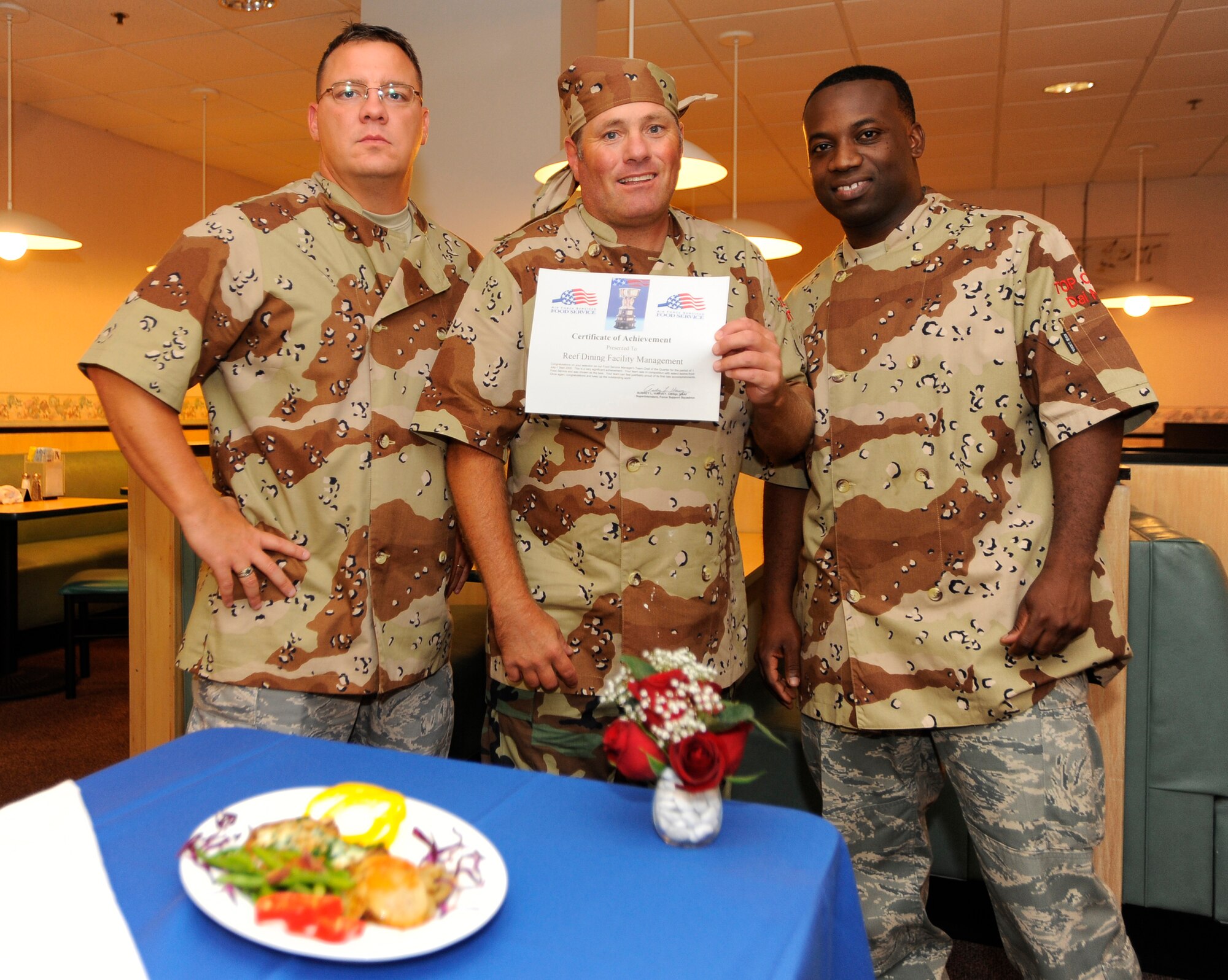 HURLBURT FIELD, FL-- Master Sgt. Carl Kendall, Tech. Sgt. Allan Ratley and Staff Sgt. Daimian Noyan, all assigned to the 1st Special Operations Force Support Squadron, stand next to their meal after winning the food services management chef of the quarter award Jul 21. (U.S. Air Force photo/Senior Airman Jason Epley)