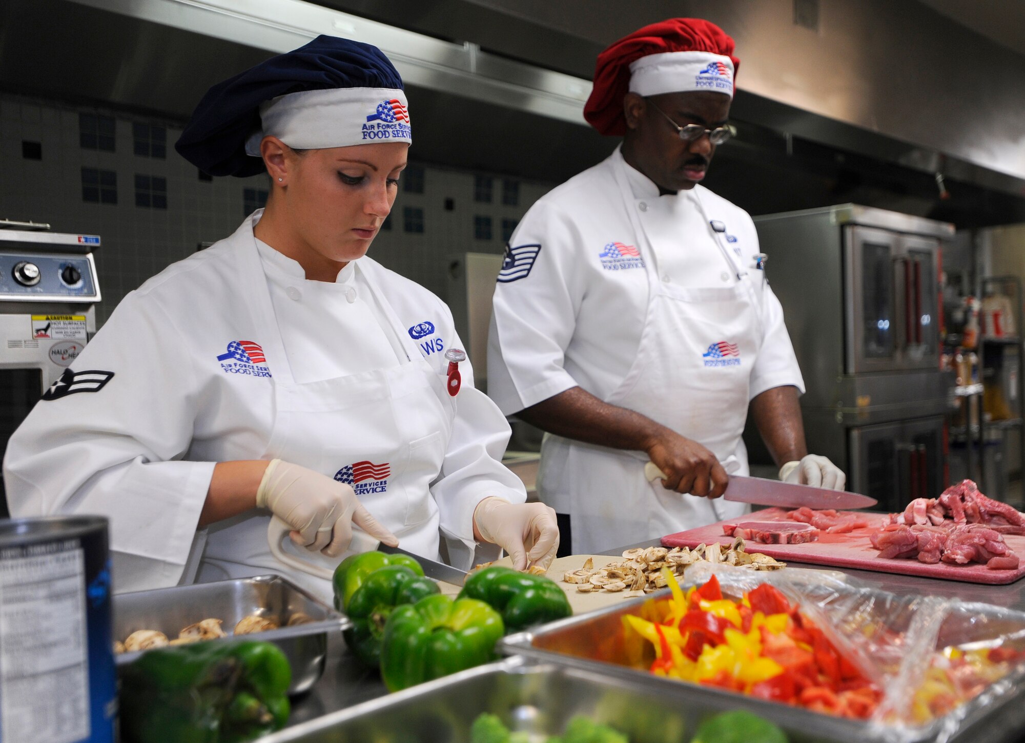 HURLBURT FIELD, FL-- Airman 1st Class Laken Hawkes and Master Sgt. Barry Smith, both assigned to the 1st Special Operations Force Support Squadron, prepare ingredients during the food services management chef of the quarter competition July 21. Each team had one hour and thirty minutes to prepare their meal for the judges. (U.S. Air Force photo/Senior Airman Jason Epley)