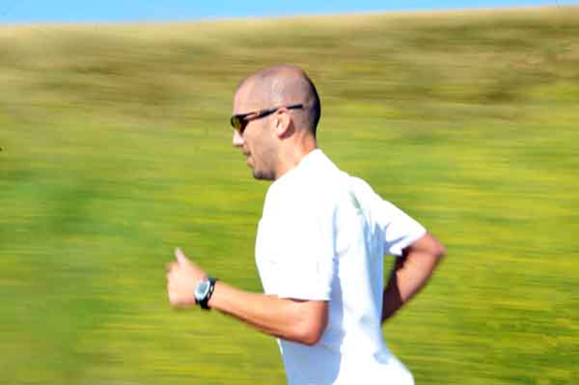 Tech. Sgt. Lawrence Hagdorn of the Air Force Financial Service Center runs, on the trail during the Raider Challenge Biathlon, July 17. The third annual Raider Challenge Biathlon is held at Ellsworth to promote fitness and boost morale. (U.S. Air Force photo/Airman 1st Class Adam Grant)

