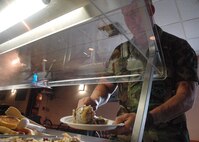 Airman 1st Class Gary Rishel, 919th Civil Engineer Squadron, helps himself to the hot bar buffet for the Saturday evening meal during the UTA at the Outpost club. The Outpost Club, located on Duke Field next to lodging, has expanded its hours of operation and its list of activities and services provided for reservists and civilians at Duke Field. The Outpost is now serving Saturday evening meals from 4:30-6 p.m. for reservists in UTA status. As well as providing good food, the club also has $1 “Quick Shot” bingo, karaoke and a full bar with discounted drinks. Hours of operation are Monday – Friday, 11 a.m. to 1 p.m. for lunch, while the bar is open every Friday 3:30-7 p.m.  and UTA Fridays and Saturdays until 10 p.m.  (U.S.  Air Force Photo/Staff Sgt. Jon McCallum)