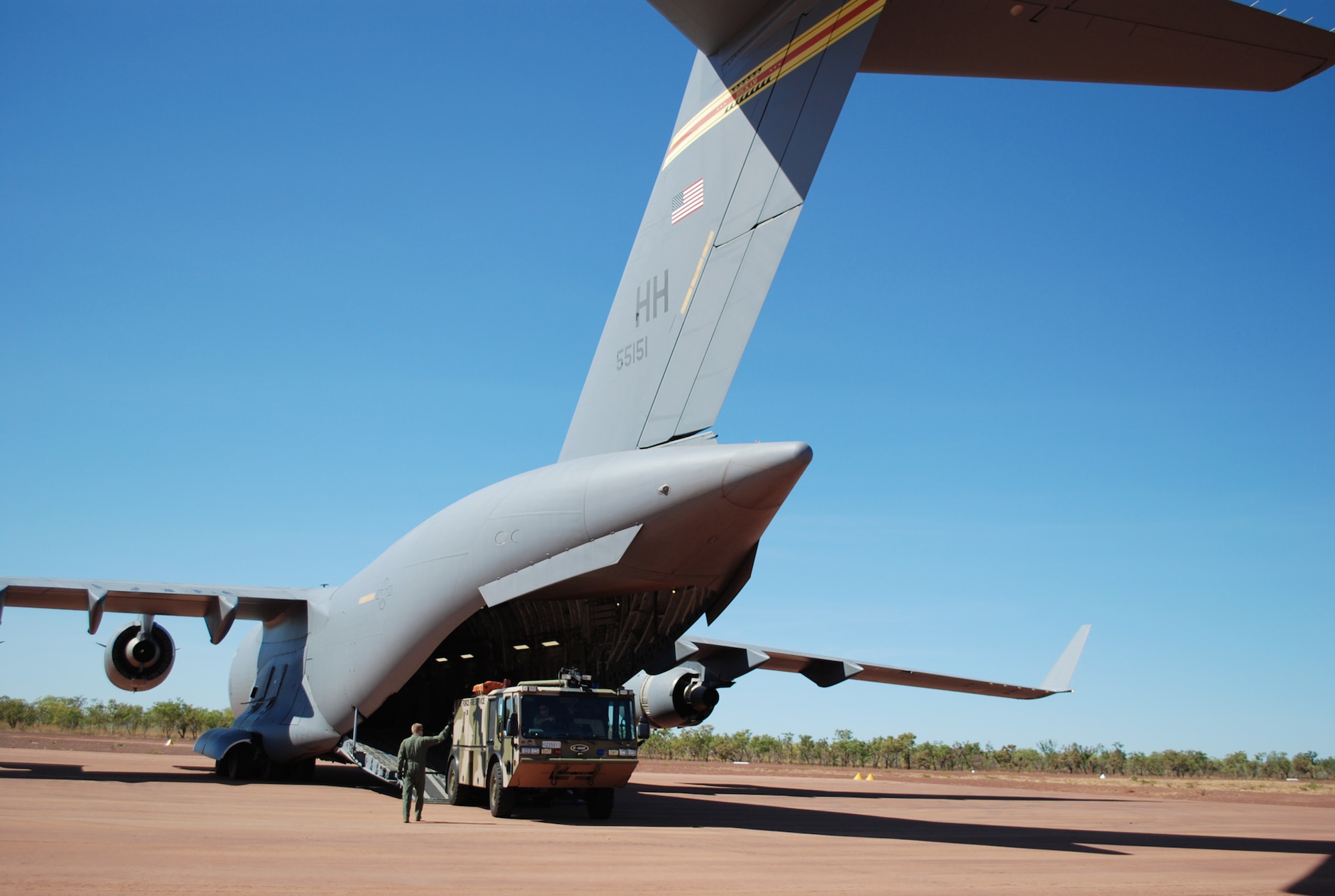 A Royal Australian Air Force E-One Titan is off-loaded July 19 at Bradshaw Field Training Area, Australia during Talisman Saber 2009. The fire truck and a six-member fire team of three U.S. and three Australian firefighters were airlifted via C-17 Globemaster III. (U.S. Air Force photo/Capt. Bryan Lewis)