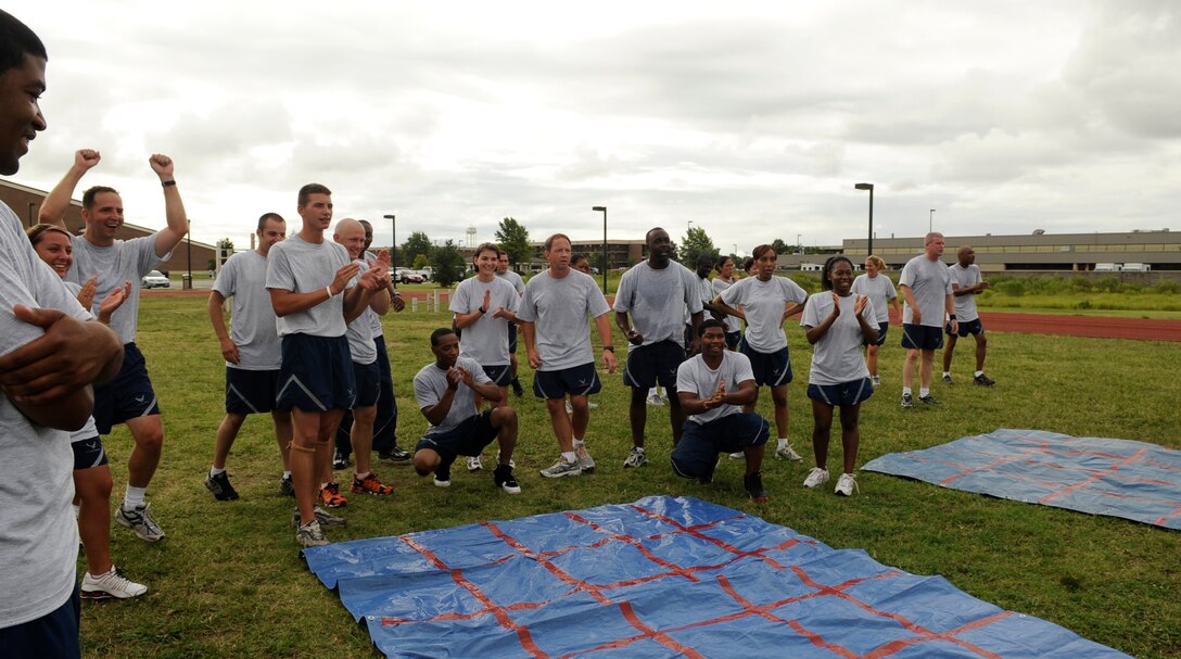 LANGLEY AIR FORCE BASE, Va. -- Chief master sergeants and Airmen cheer their team members on during the Airmen Committed to Excellence and Chiefs Day here July 23.  Air Combat Command and the 1st Fighter Wing came together to participate in a fun day of mentoring Airmen. (U.S. Air Force Photo/Senior Airman Dana Hill)