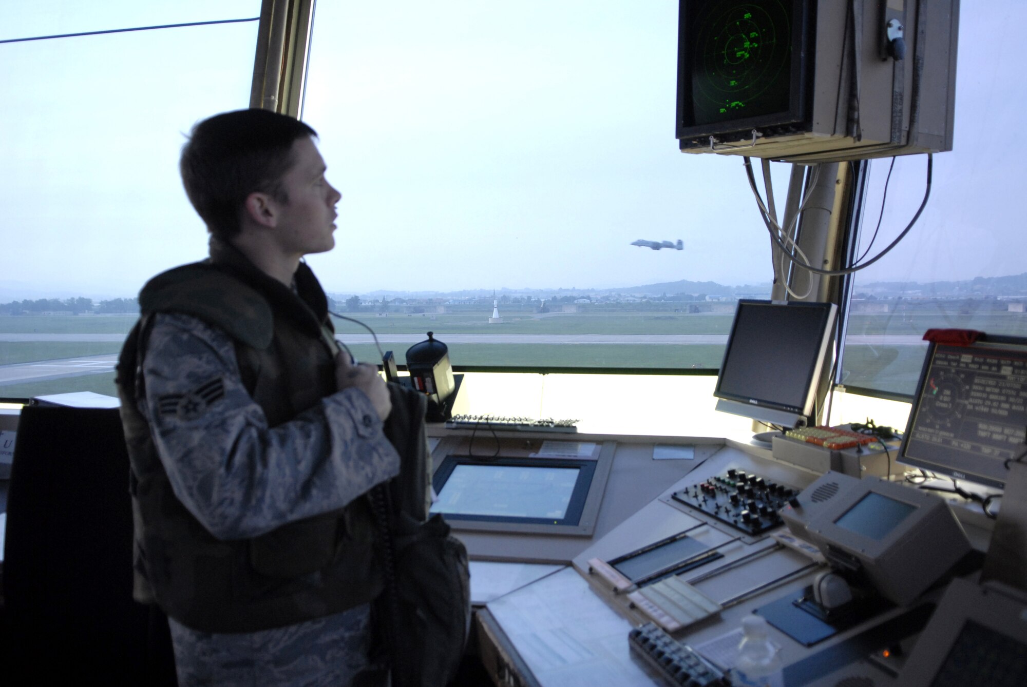 Senior Airman Joshua Snelling clears an Aircraft for take off while controlling traffic during exercise Beverly Bulldog 09-03 at Osan Air Base, Republic of Korea, July 23.  Airman Snelling is an air traffic controller with the 51st Operations Support Squadron. (U.S. Air Force photo/Senior Airman Stephenie Wade)