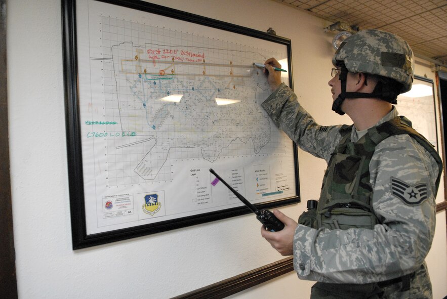 Staff Sgt. Lee Grundmann plots damage to the flightline on a map after alarm black, general release has been announced during exercise Beverly Bulldog 09-03 at Osan Air Base Republic of Korea, July 23. (U.S. Air Force photo/Senior Airman Stephenie Wade)