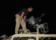 CREECH AIR FORCE BASE, Nev. -- An Army Special Forces soldier conducts pre-mission checks on the mounted .50 caliber machine gun before embarking on a Red Flag 09-4 night operation. Air Force and Army ground forces typically travel in armored vehicles during Red Flag missions and in deployed locations. (U.S. Air Force photo/2nd Lt. Emily Chilson)
