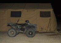 CREECH AIR FORCE BASE, Nev. -- Special Forces teams use four-wheel all-terrain vehicles for increased maneuverability in addition to armored vehicles when on missions in the Nevada Test and Training Range, and in deployed enivornments. This ATV is parked outside the teams' Base X modular tent system, which provides enough room and storage area for all personnel, supplies and equipment. (U.S. Air Force photo/2nd Lt. Emily Chilson)