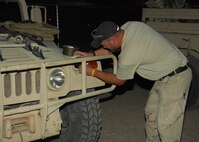 NELLIS AIR FORCE BASE, Nev. -- An Army Special Forces Soldier adjusts an Infrared light on an armored vehicle while preparing for a Red Flag 09-4 night mission. Both Air Force and Army ground forces at Red Flag work with pilots from all branches of the military to hone Close Air Support skills. (U.S. Air Force photo/2nd Lt. Emily Chilson) 