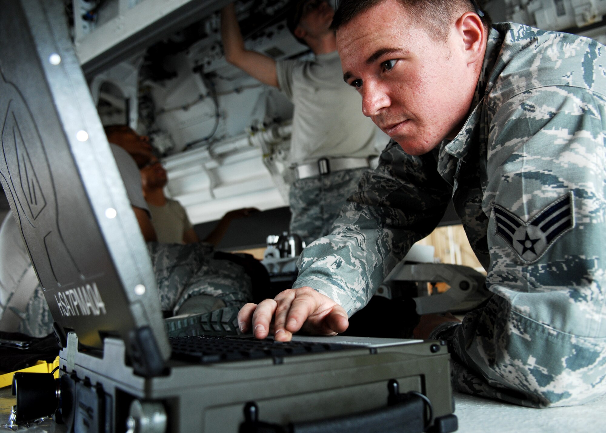 Senior Airman Justin Hall, 49th Maintenance Operations Squadron, reads the technical orders out loud from the Portable Maintenance Aid to his classmates during the F-22A Raptor Armament Weapons Bay Door System and Suspension Components Maintenance Course, July 15, at Holloman Air Force Base, N.M.  Students learn how to perform reliable electric test through COLT testing (Common organizational level tester) which simulates aircraft munitions.


 (U.S. Air Force photo/SSgt Anthony Nelson Jr)