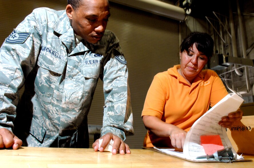 Tech. Sgt. Aaron Blackwell, F-22A Raptor Weapons Instructor, and Christine Kent, check and inventory F-22 engine equipment July 14, at Holloman Air Force Base, N.M. Ms. Kent is the Aircraft Parts Store Liaison (APS) for Pratt and Whitney and is assigned to the 3rd Component Maintenance Squadron at Elmendorf Air Force Base, Ala. Sergeant Blackwell is assigned to Det. 10, 372nd Training Squadron at Sheppard Air Force Base, Texas. (U.S. Air Force photo/SSgt Anthony Nelson Jr)