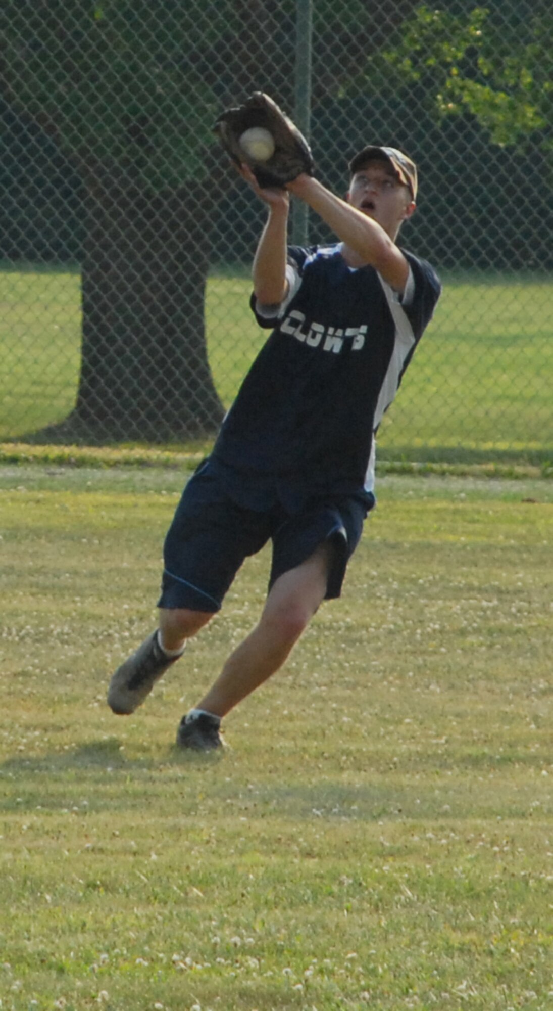 Michael Leathers, 736th Aircraft Maintenance Squadron right fielder, catches a pop fly during a softball game against 436th Maintenance Squadron July 16.  736th AMXS defeated 436th MXS 9-5.  (U.S. Air Force photo/Staff Sgt. Chad Padgett)