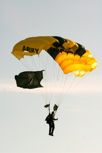 MINOT AIR FORCE BASE, N.D. -- A member of the U.S. Army Golden Knight parachute team descends on Minot with the Prisoner Of War/Missing in Action flag during the Northern Neighbors Day festivities here July 18. Thousands of people from the base and local community turned out to watch the 2009 Northern Neighbors Day, which came through on its promise to wow spectators with amazing aerial maneuvers, nail-biting choreography, historic displays and much more. (U.S. Air Force Photo by Airman First Class Jesse Lopez)