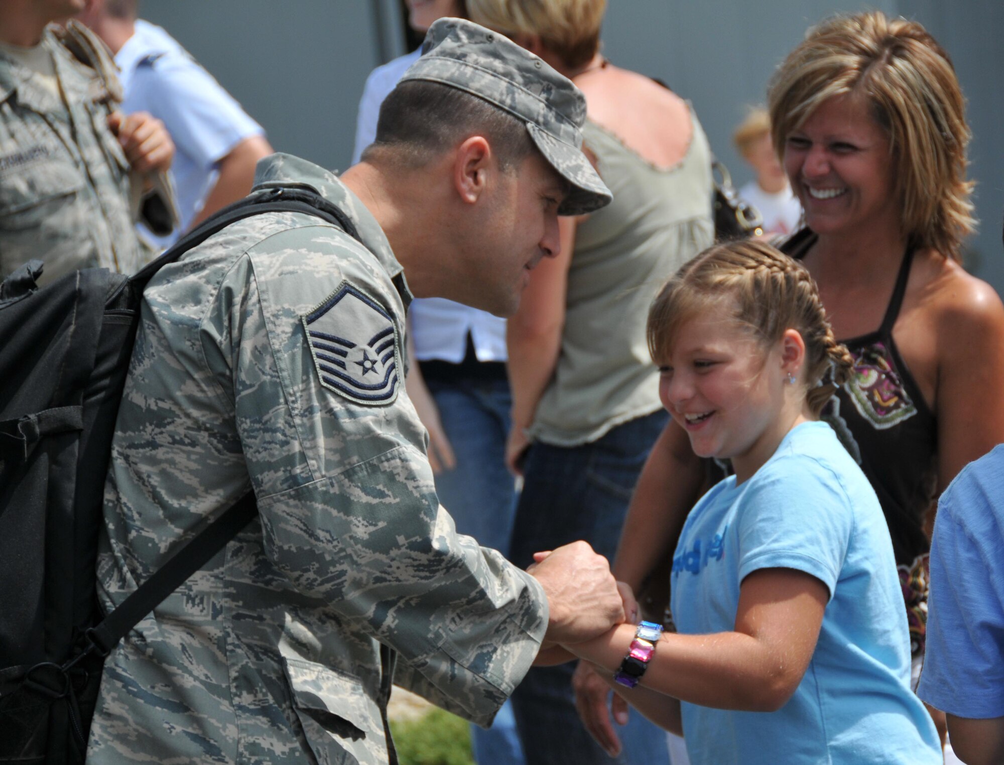 Master Sgt. Brian McInnis, 934th Security Forces Squadron, gets reacquainted with his family today at Minneapolis St. Paul International Airport Air Reserve Station after a seven month deployment to Southwest Asia. (Air Force Photo/Master Sgt. Paul Zadach)