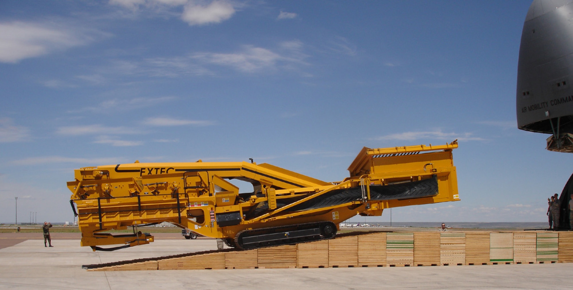 The 819th RED HORSE Squadron members remaining at Malmstrom had to build an additional 20-feet of shoring ramp at the last minute in order to get this rock crusher to a level position prior to it entering the cargo area of the C-5, shown here. It took 300 manhours in one day to build the additional shoring. (U.S. Air Force photo/Tech. Sgt. John Cottle)