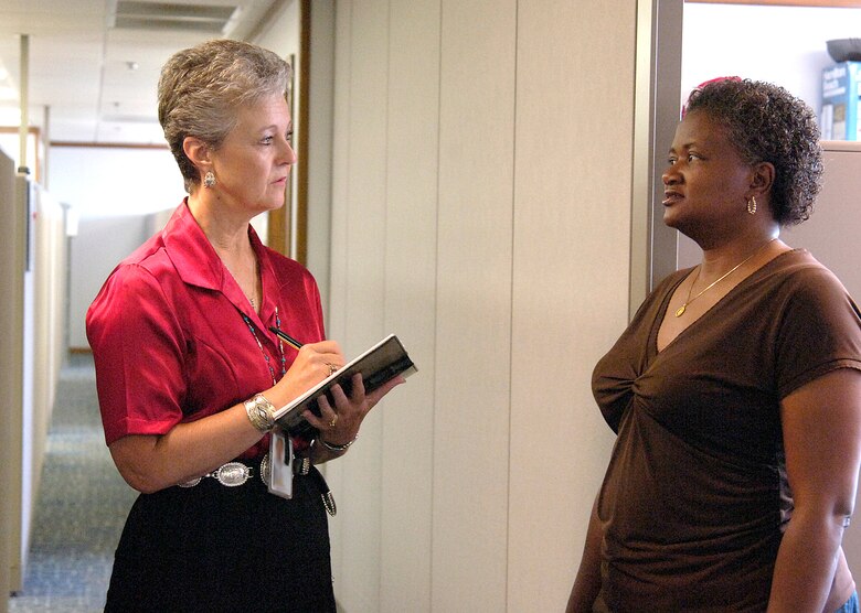 As a unit public affairs representative, or UPAR, workers like Gail Kulhavy, left, share news from their organizations with Tinker and the Air Force.  Ms. Kulhavy visits with co-worker Tanya Whitfield, both from Information Technology in the Oklahoma City Air Logistics Center. (Air Force photo by Margo Wright)