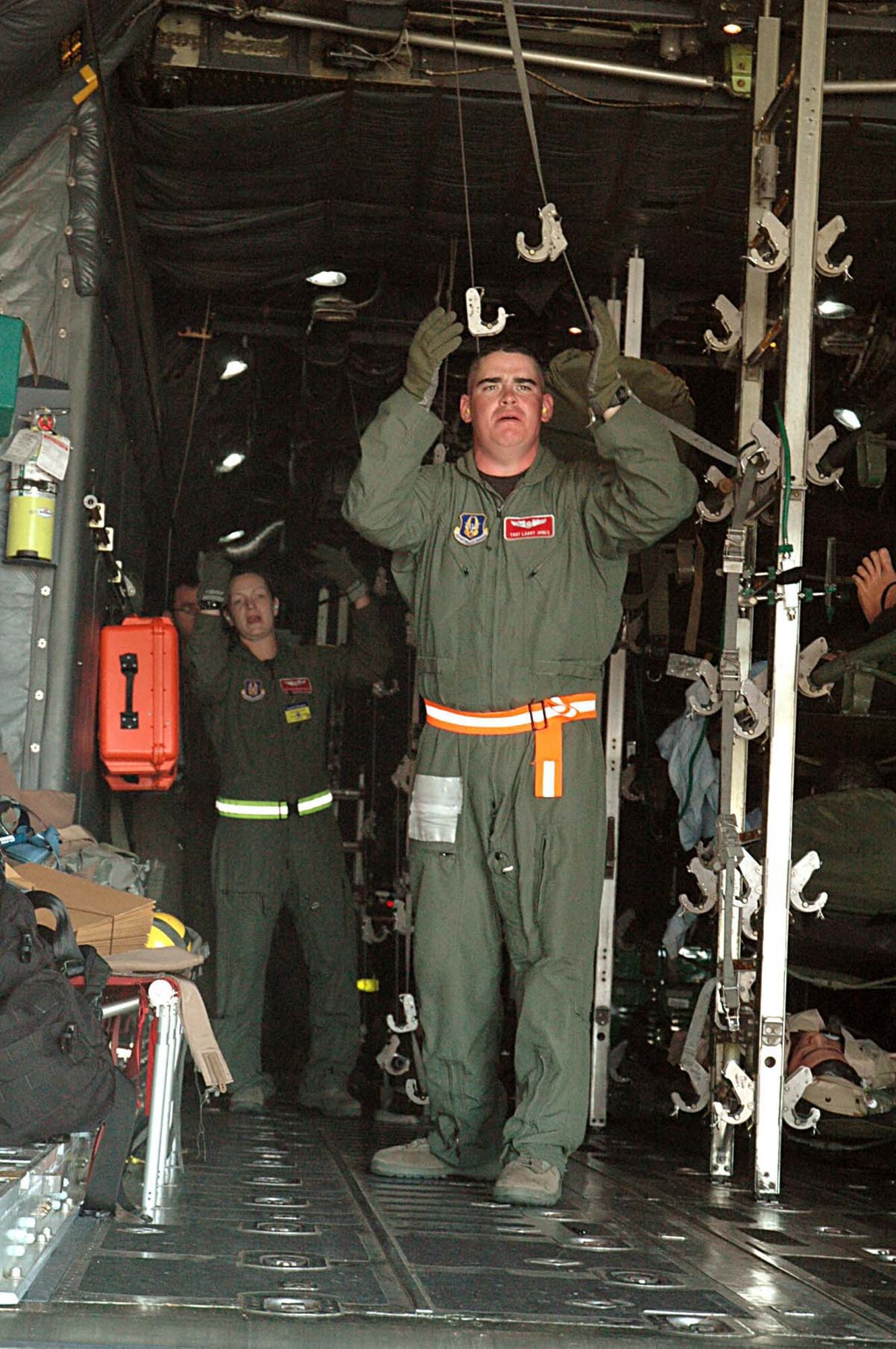 Tech. Sgt. Larry Jones, front, and Senior Airman Krystil Reinstadler, 446th Rodeo Aeromedical Evacuation team, McChord Air Force Base, Wash., direct the loading of patients during their contingency flight event July 20.  The contingency flight is one of three events aeromedical evacuation teams participate in during Air Mobility Command's Rodeo 2009 at McChord Julyn 19-24. (U.S. Air Force photos/Airman 1st Class Patrick Cabellon)