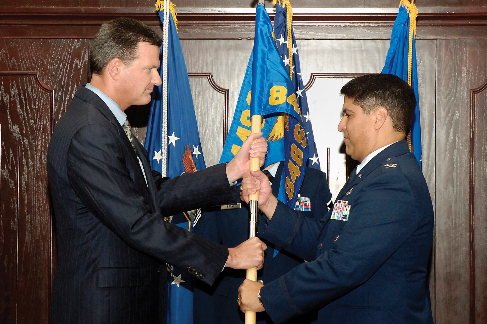 Col. Luis Rosa-Berrios receives the unit guidon from 448th Supply Chain Management Wing director Scott Reynolds during an assumption of command ceremony July 16. (Air Force photo by Kelly White)